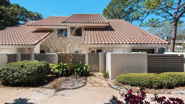 A two-story house with a tiled roof, a front gate, and a well-maintained garden. - 1/2 Mile to the Beach at Sandestin + Pool: Lake Views at Beachwalk Villas (Miramar Beach)