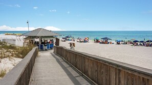 A wooden boardwalk leading to a beach with umbrellas and beach chairs. - 1/2 Mile to the Beach at Sandestin + Pool: Lake Views at Beachwalk Villas (Miramar Beach)