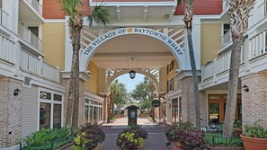 A covered walkway with a sign reading "The Village of Baytown Wharf." - 1/2 Mile to the Beach at Sandestin + Pool: Lake Views at Beachwalk Villas (Miramar Beach)