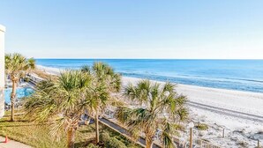 A beachfront hotel with a pool, palm trees, and a clear view of the ocean. - ☀️Gulf Front Condo with Great Views-Latitude 29 #36☀️ (Panama City Beach)