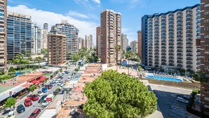 A high-rise urban area with multiple buildings, a parking lot, and a swimming pool.