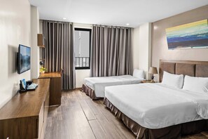 Habitación triple Deluxe, vista a la ciudad | Espacio para trabajar con laptop, wifi gratis y ropa de cama 