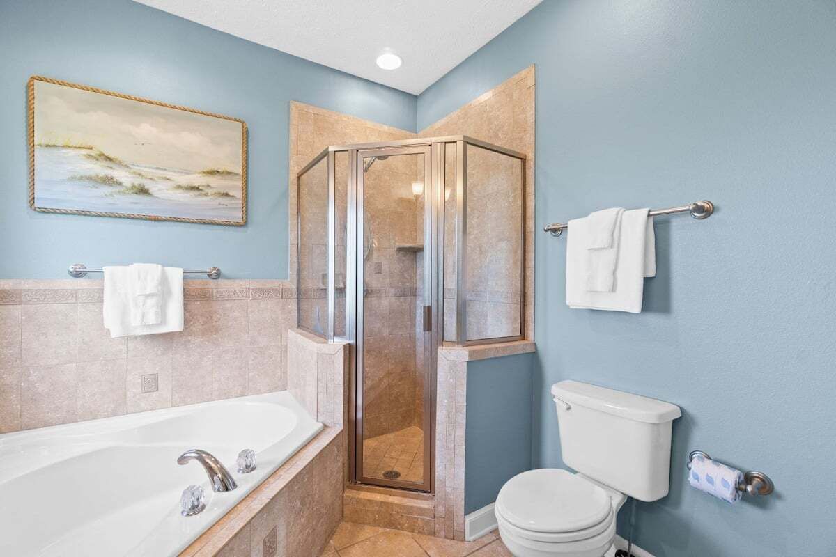 Ein Badezimmer mit einer Duschkabine, einer Badewanne und einem WC.