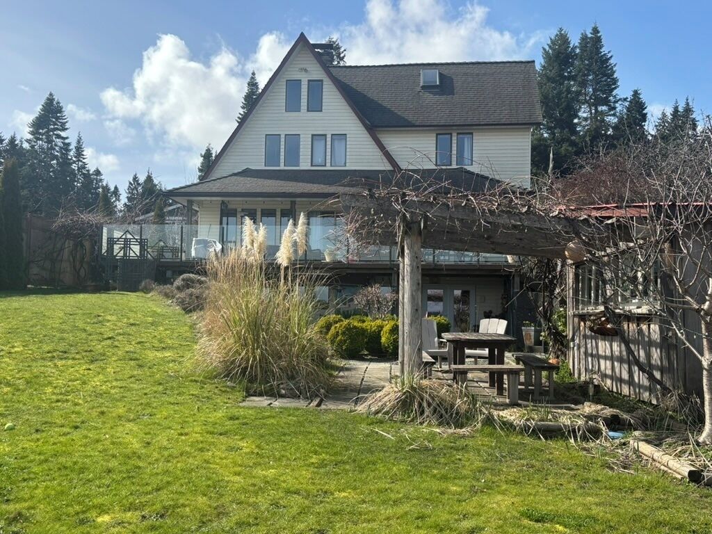 A two-story house with a covered patio area.