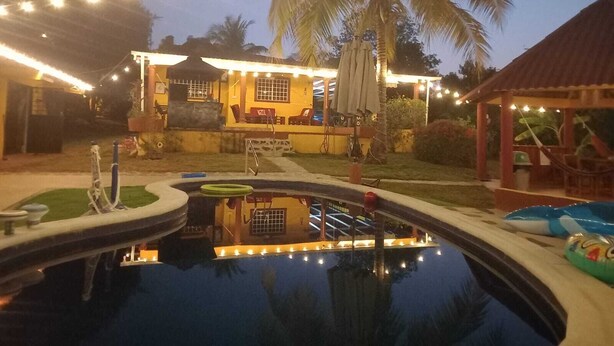 A pool area with a lounge chair, a small pool, and a gazebo. - Spacious and relaxing beach house in Paradise to share with family or friends (El Higo)