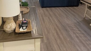 A living room with a fireplace, a sofa, a TV mounted on the wall, and a dining area with a table and chairs. - Peaceful/Spacious Downtown home Branson near Lake Taneycomo w/great amenities   (Branson)