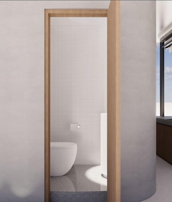 Un baño moderno con inodoro, toallero y ventana.