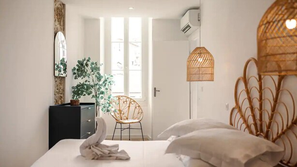 A bedroom with a bed, a dresser, a chair, and a window.