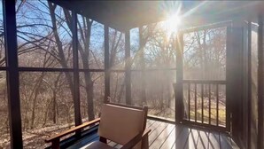 A wooden deck with a bench, surrounded by trees and a clear sky. - Chic Cabin! Less than 10 minutes from Downtown Siloam Springs (Gentry)