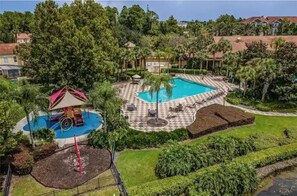 Outdoor pool - Cozy 2-bedroom townhome in lovely gated community in Kissimmee- Close to Disney. (Kissimmee)
