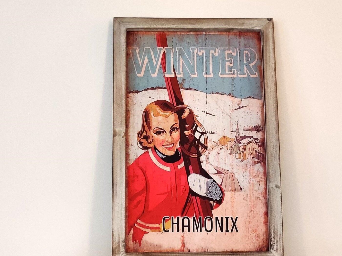 A vintage poster with the word 'WINTER' and the name 'CHAMONIX' on it.