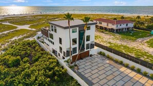 A modern two-story building with a flat roof, large windows, and a balcony. - Shangri-La | Bean Point | Rooftop Pool | Golf Cart (Anna Maria)