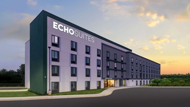 A modern hotel building with the name 'ECHO SUITES' prominently displayed. - ECHO Suites Extended Stay by Wyndham Spartanburg (Spartanburg)