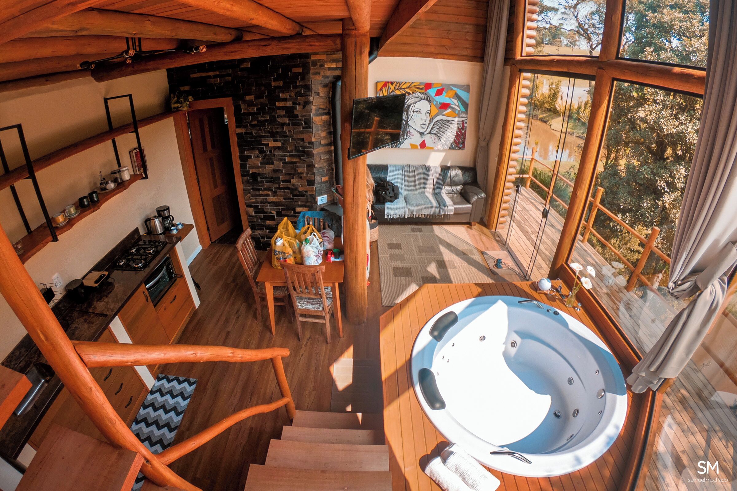 Interior acogedor de una cabaña con cocina, comedor y un jacuzzi.