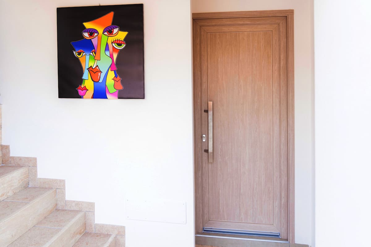 A staircase leading to a wooden door with a metal handle.