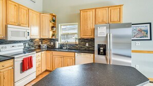 A kitchen with wooden cabinets, a stainless steel refrigerator, a microwave, an oven, and a dishwasher. - 6 Mi to Skiing: Mtn-View Fraser Duplex (Fraser)