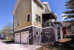 A two-story residential building with a garage, a balcony, and a small porch. - Horseshoe Haven, Immaculate 2BD/2BA, Pet friendly! (Mt. Crested Butte)