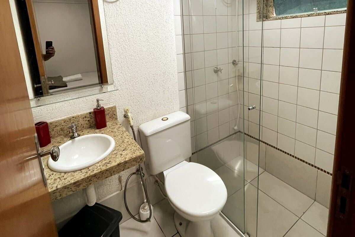 A bathroom with a sink, toilet, and shower.