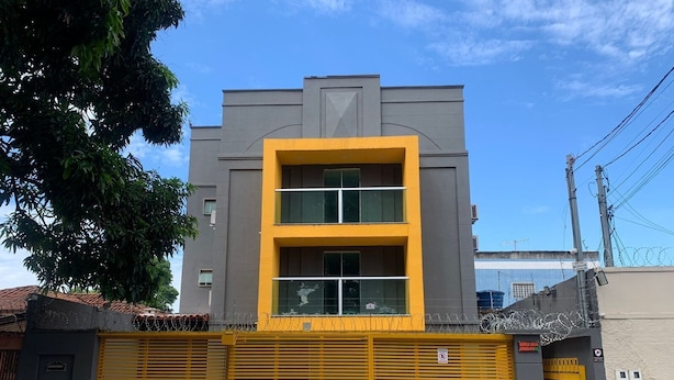 A building with a grey facade and a yellow window. - Residencial Carajás (Goiania)