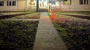 A pathway leading to a building with a sign reading "EASTERN HOUSE." - Grand Lake Hotel (Lebanon)