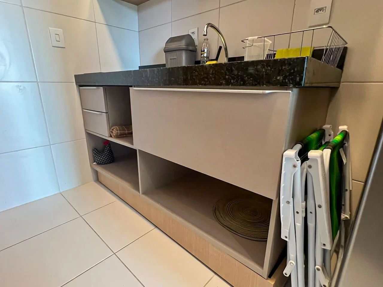 A kitchen with a countertop, a sink, and a built-in oven.