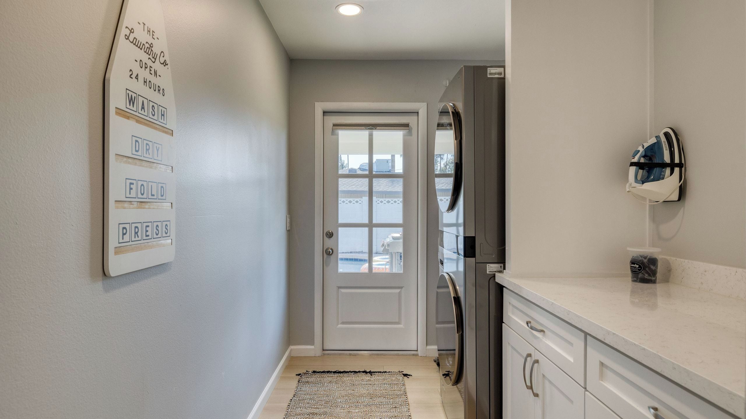 A kitchen with a refrigerator, a microwave, and a coffee machine.