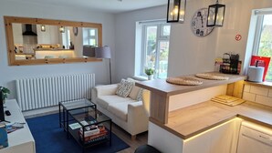 A modern kitchen with a white countertop, a built-in oven, and a window above the sink. - NEW 2 bedrooms with private en-suite near Heathrow (Ashford)