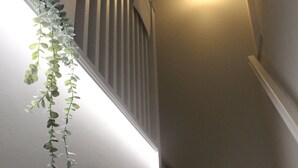 A staircase with wooden steps and a light fixture at the top. - NEW 2 bedrooms with private en-suite near Heathrow (Ashford)