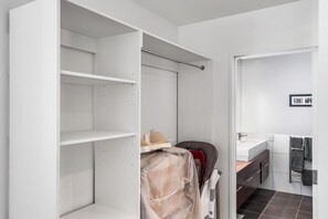 A bathroom with a white sink, dark tiled floor, and a towel rack.