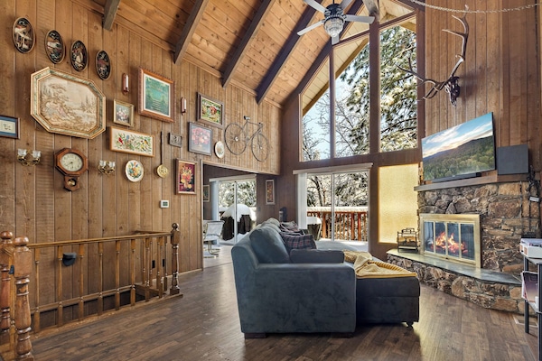 Cozy up by the indoor wood-burning fireplace and 60" smart TV with.