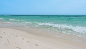 A beach with clear turquoise water and a sandy shore. - 1br/1ba, Covered Parking, Perfect for Couples! (Panama City Beach)