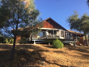 A two-story house with a covered porch and a small deck.