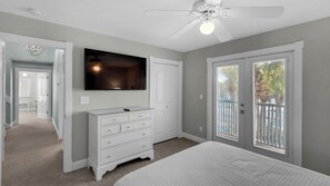 A bedroom with a bed, a dresser, a TV, and a ceiling fan. - 2 Minutes to Beach & Next to Pool - Free Beach Setup, Sleeps 12 (Santa Rosa Beach)