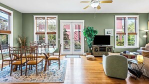 A spacious living room with a dining area, large windows, and a ceiling fan. - 2 Minutes to the Gulf - Sleeps 10 in Seagrove Beach (Santa Rosa Beach)