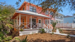 A two-story house with a porch, a balcony, and a small deck.