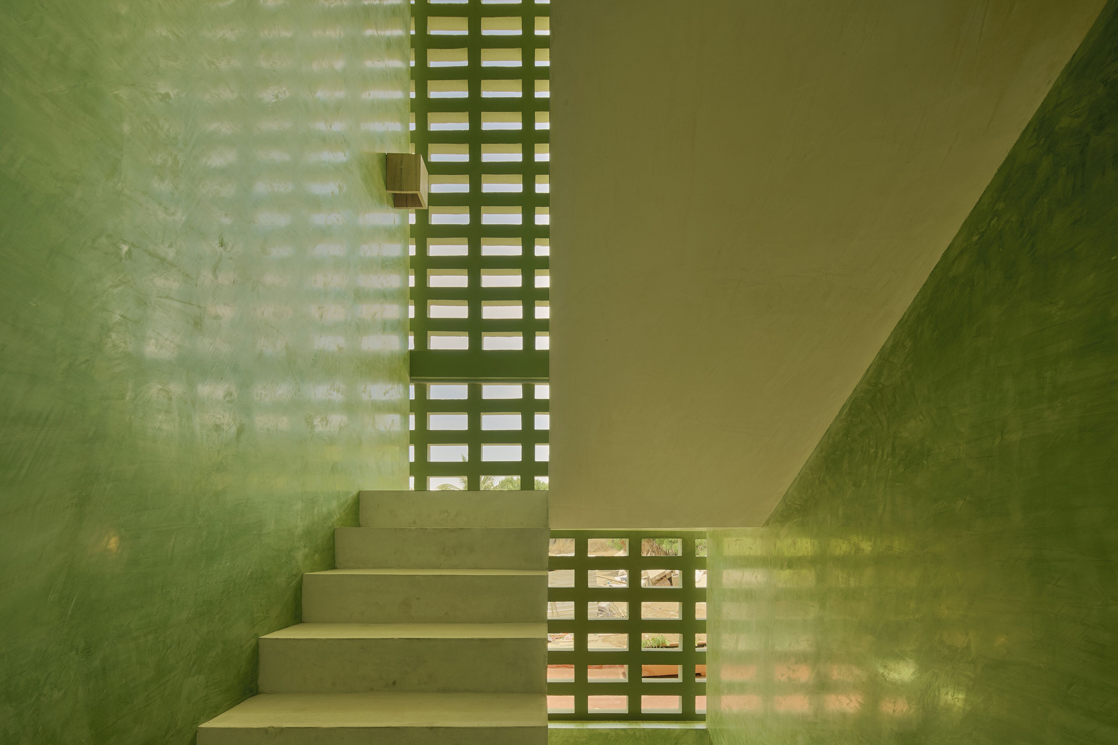 A staircase with a green lattice structure on the right side.