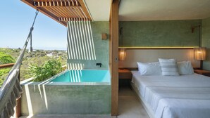 A bedroom with a large bed, a small window, and a view of the landscape. - Punta Nayaá - Adults Only (Santa Maria Colotepec)