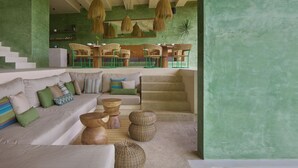 A modern living area with a sofa, chairs, and a staircase. - Punta Nayaá - Adults Only (Santa Maria Colotepec)