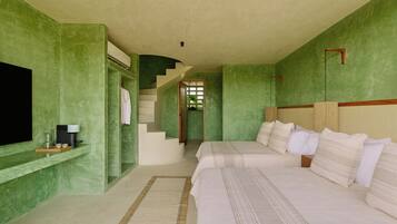 Un dormitorio con pared verde, televisor, mesita de noche, cama con ropa blanca y una escalera que lleva a otra habitación.