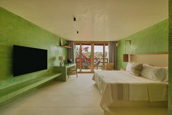 A bedroom with a bed, a flat-screen TV, a desk, and a chair. - Punta Nayaá - Adults Only (Santa Maria Colotepec)