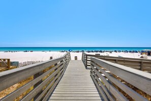 A wooden boardwalk leading to a beach with clear skies. - 3BR Home /beach Access/spacious Deck/zoo Across (Panama City Beach)