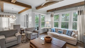A spacious living room with a large sofa, two armchairs, a coffee table, and a dining area. - 4 Minutes to Beach + Community Pool ~ Stunning Modern Home for 12 (Santa Rosa Beach)