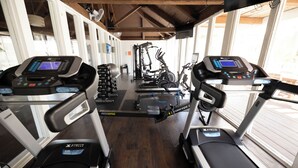 A gym with treadmills, a rowing machine, and weight equipment.