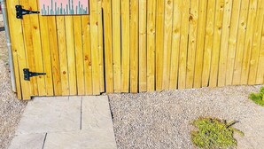 A wooden fence with a sign that reads "SKY HARBOR SUITE".