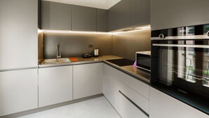 A modern kitchen with built-in appliances, a sink, and a countertop. - Spacious and bright penthouse with 3 small balconies (Verona)