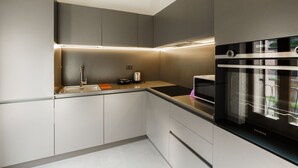 A modern kitchen with built-in appliances, a sink, and a countertop. - Spacious and bright penthouse with 3 small balconies (Verona)