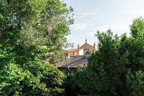 A building with a traditional architectural style, surrounded by dense greenery. - Merici residence, elegant and fairytale-like (Verona)
