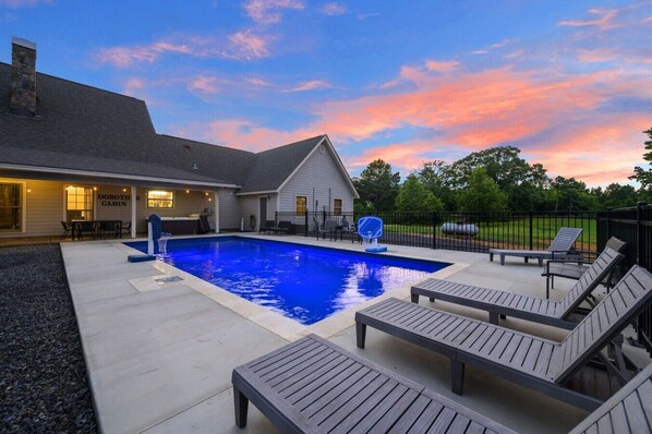 A swimming pool with lounge chairs, a covered area, and a building labeled 'Doroth Cabin'.