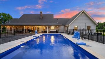 A residential property with a swimming pool, a covered patio, and a separate building with a sign that reads 'DOROTHY'S CAFE.'