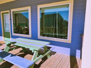Enjoy outdoor dining or relaxation on the deck with a picnic table and benches.